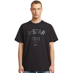 Man wearing a black t-shirt with 'G-Star' branding on a white background